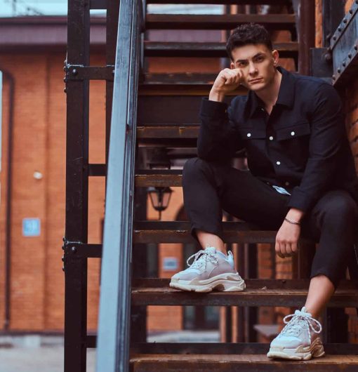 a-young-pensive-guy-sitting-on-stairs-outside-near-G67LNXF-scaled.jpg